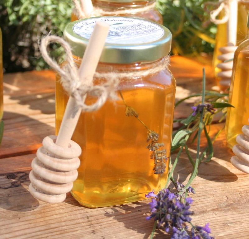 Lavender Infused Honey in glass jar with honey dipper by Bee Lovely